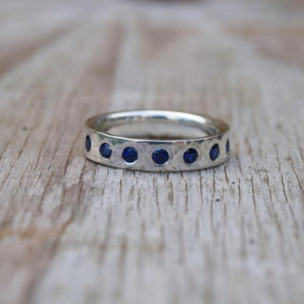 Silver band flush set with sapphires