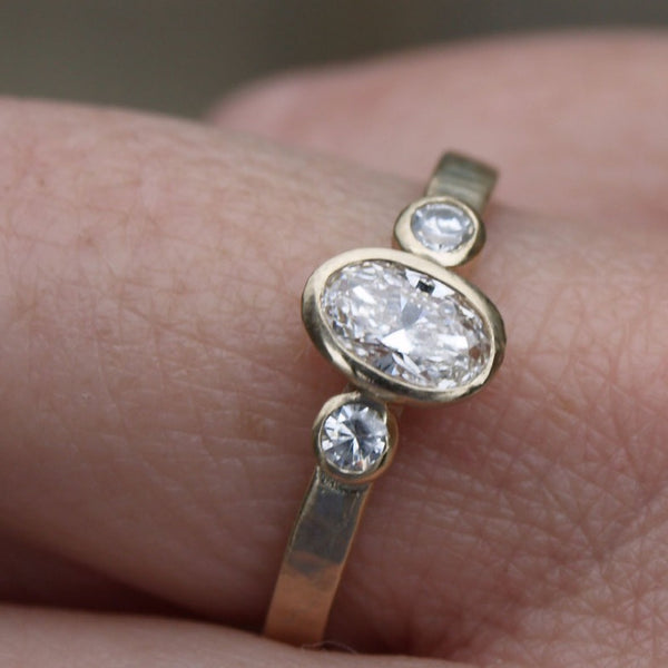 Recycled gold diamond trilogy engagement ring