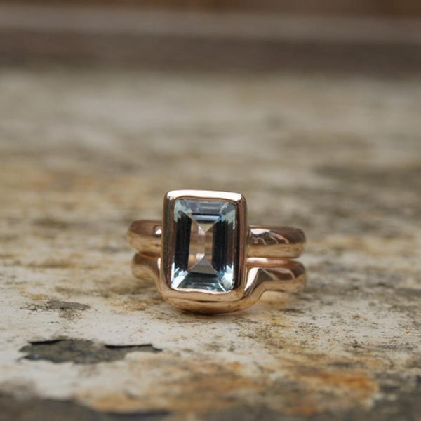 Emerald cut aquamarine ring set in recycled rose gold