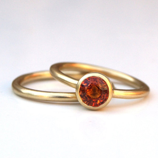 Orange sapphire ring set in recycled 18ct yellow gold