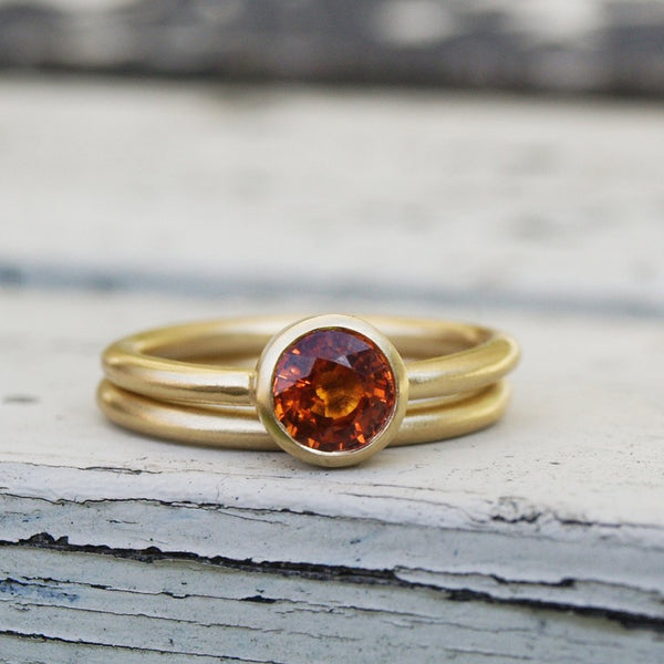 Orange sapphire ring set in recycled 18ct yellow gold