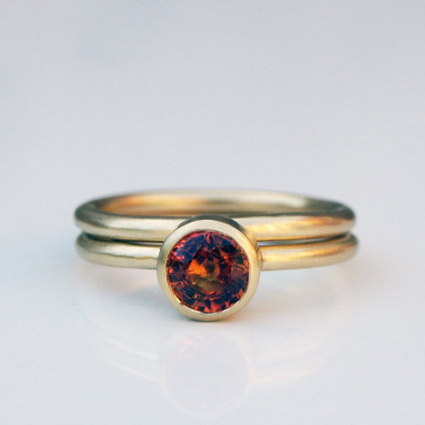 Orange sapphire ring set in recycled 18ct yellow gold