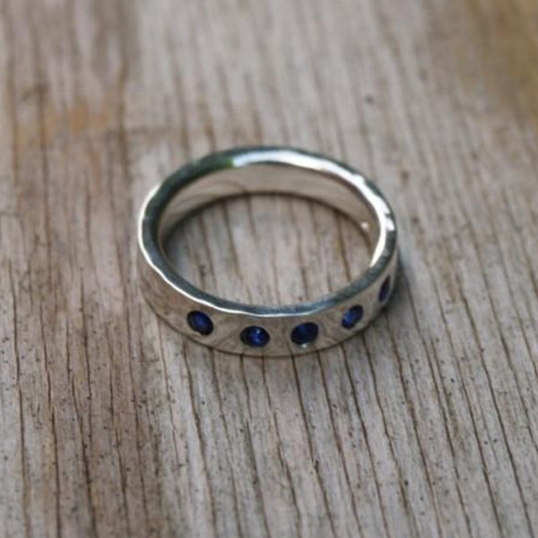 Silver band flush set with sapphires