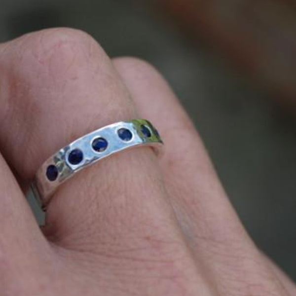 Silver band flush set with sapphires