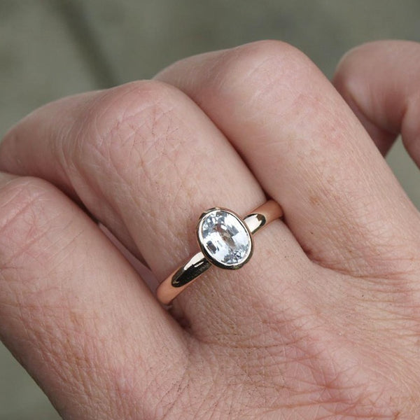 Rose gold ring with oval white sapphire