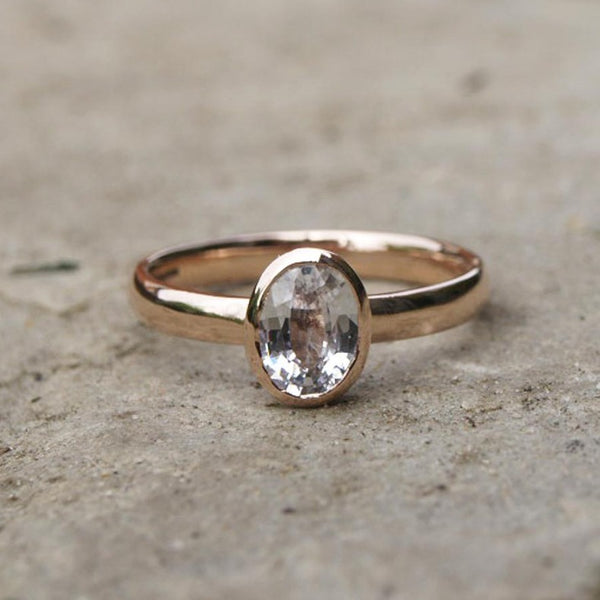 Rose gold ring with oval white sapphire